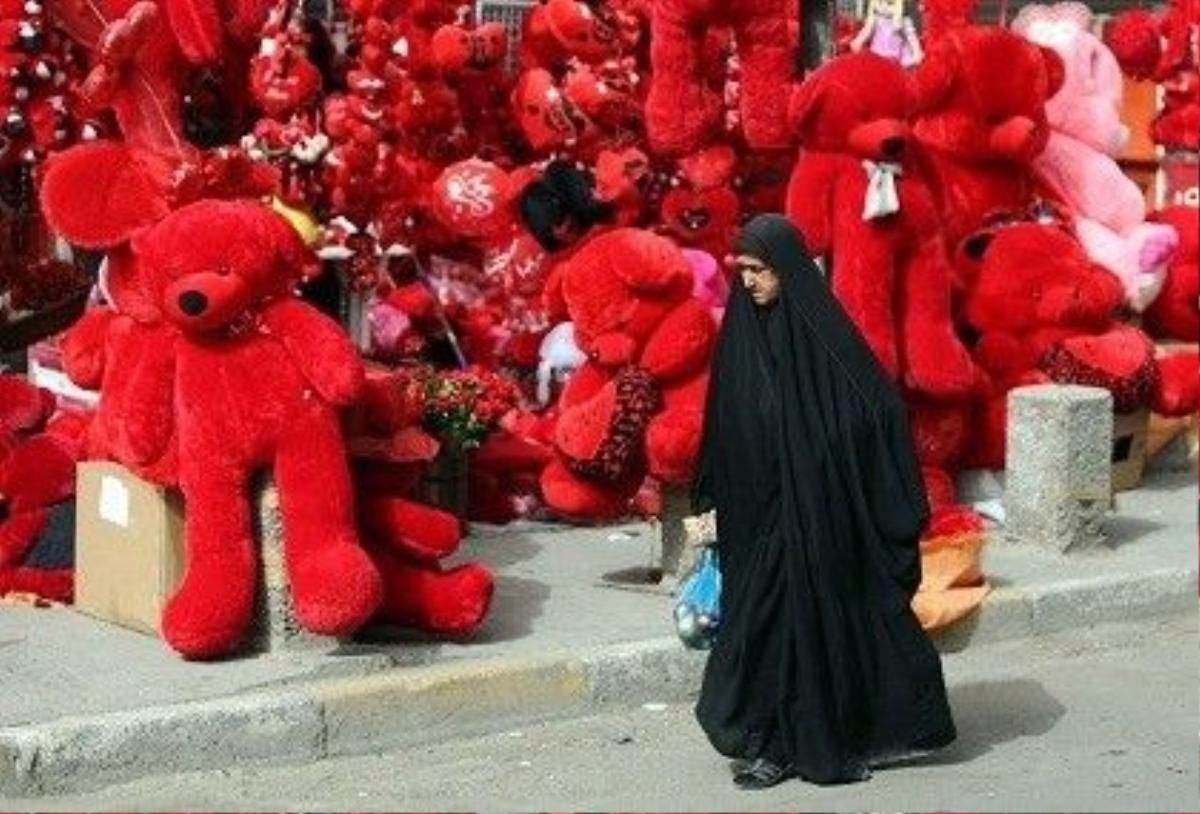 An Iraqi woman walks past a shop displaying red teddy bears in preparation for Valentine's day in Baghdad's Karrada district on February 12, 2014. AHMAD AL-RUBAYE/AFP/Getty Images